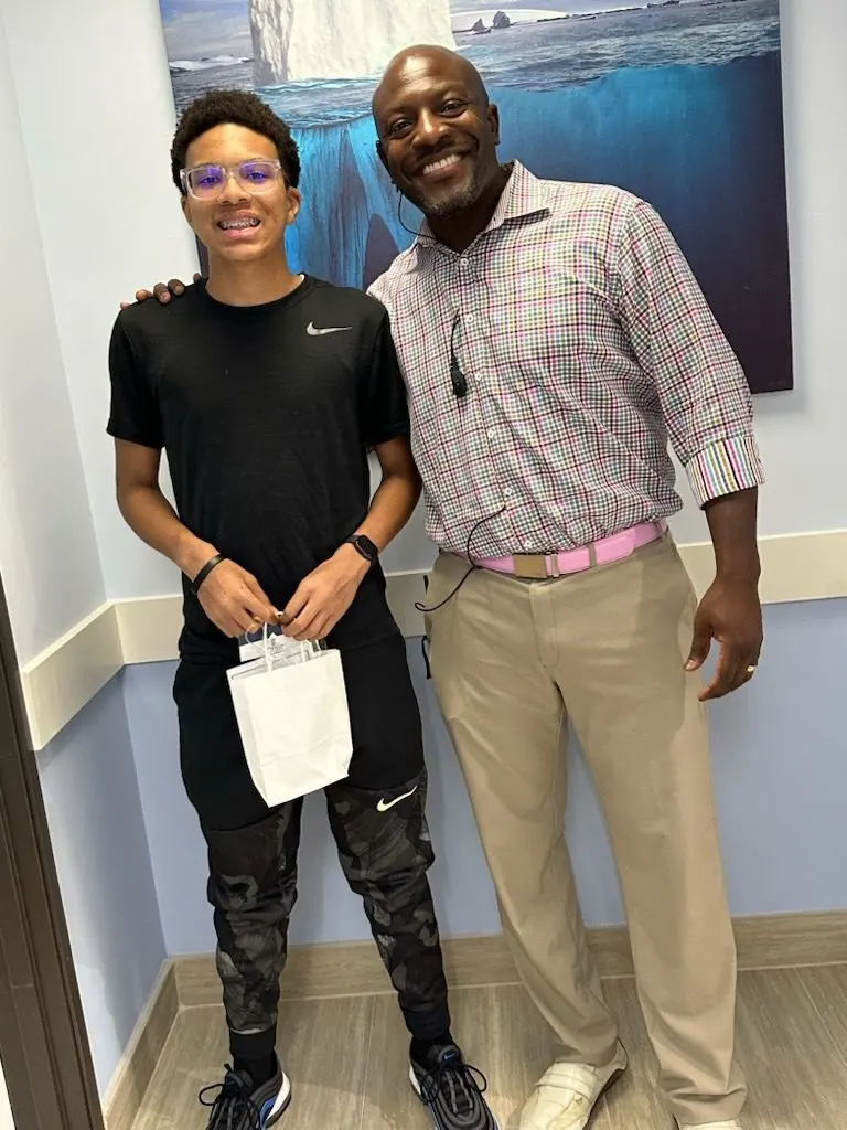 Dr. Kishawn Kole-James with a teen patient holding a Superior Orthodontics gift bag